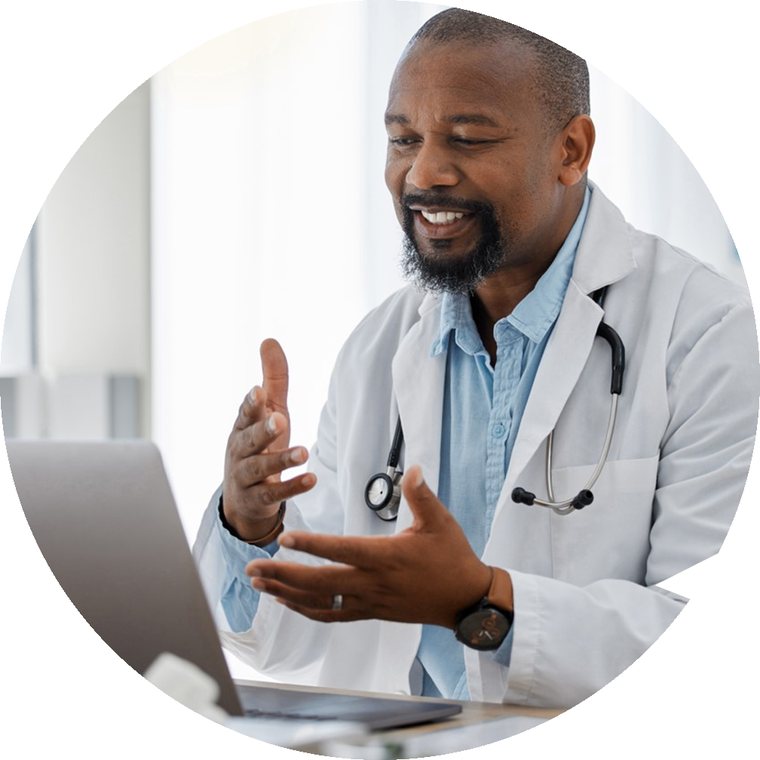 A physician reviewing a patient's medications on a laptop